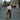 Woman walking down a street holding a brown tote bag