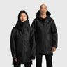 Two people wearing black hooded raincoats on a light gray background