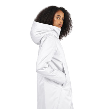 A woman with curly black hair is shown from the side wearing a white hooded winter jacket against a plain white background.