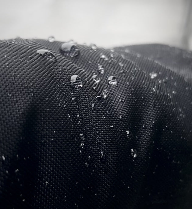 Rain drops roll off the Econyl material on the sleeve of a Bedi coat