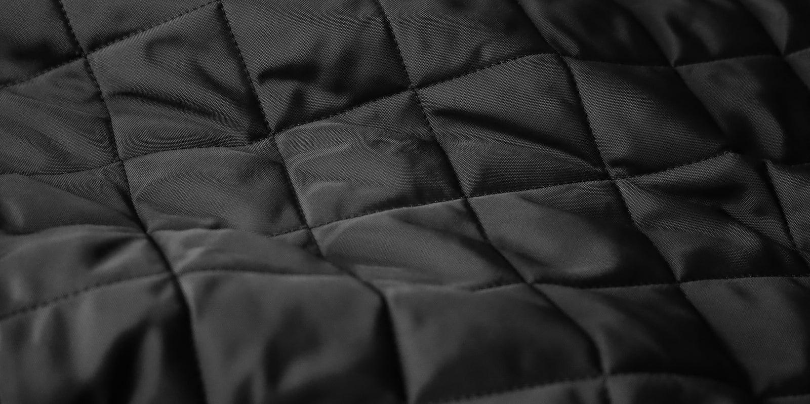 a rotating selection of five colours of the same quilted jacket, with different backgrounds that reflect the colour of each coat