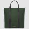 A large minimalist tote bag in green nylon material, with a black strap that runs the height of the bag