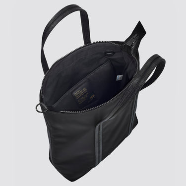 Black tote bag with an interior brand logo on a light grey background