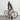 Woman standing next to a bicycle wearing a green jacket and beige pants in an indoor setting.