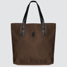 Brown tote bag with black handles on a light gray background
