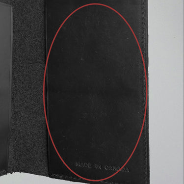 Black leather-bound book with 'Made in Canada' stamp on a gray background