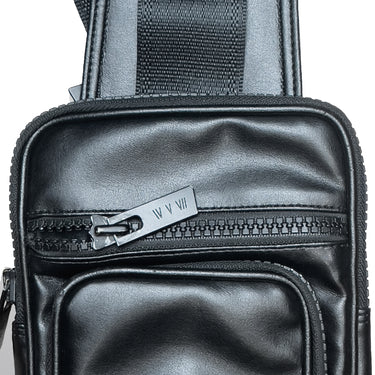 Close-up of a black bag with a zipper and visible brand logo on a white background